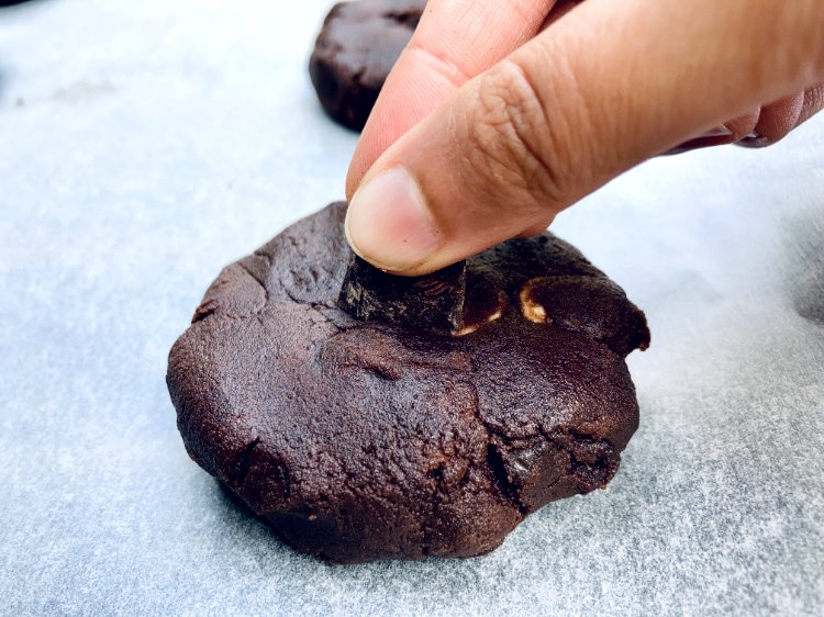 Image of Gently insert a chocolate chunk into the centre of each...